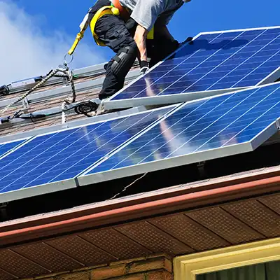 Worker installing solar panels